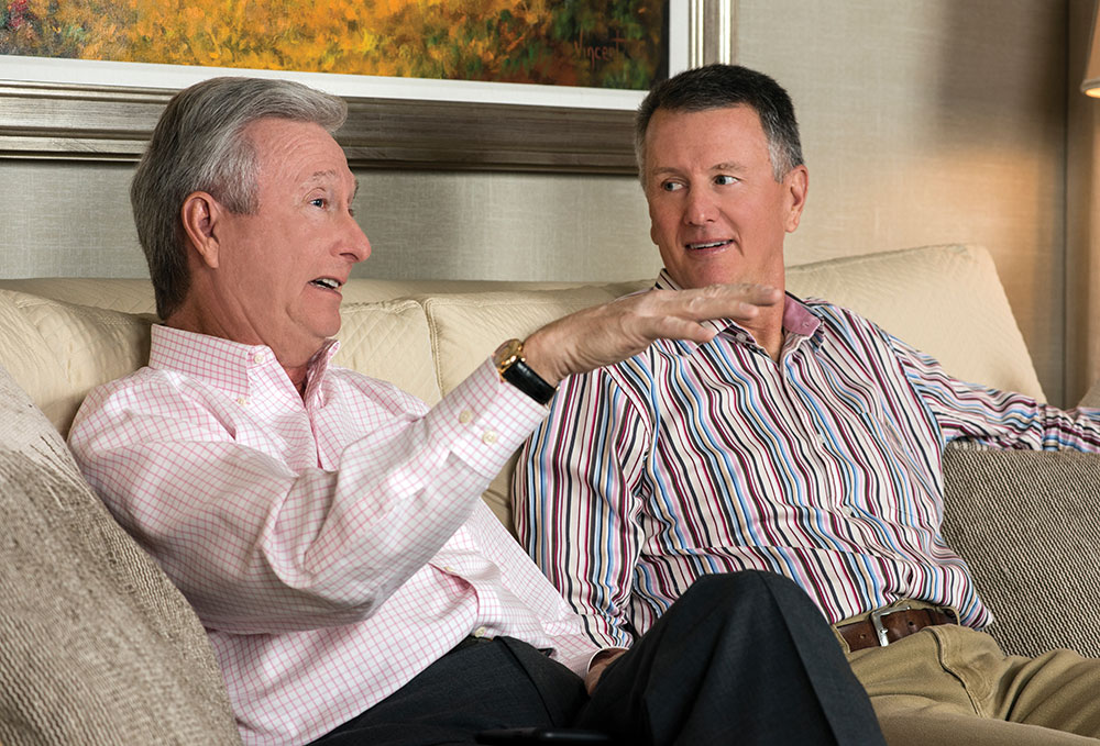 Jeff Diermeier and Rick Diermeier talk on a couch