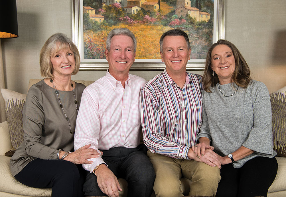 Jeff Diermeier and Rick Diermeier flanked by their wives on a couch