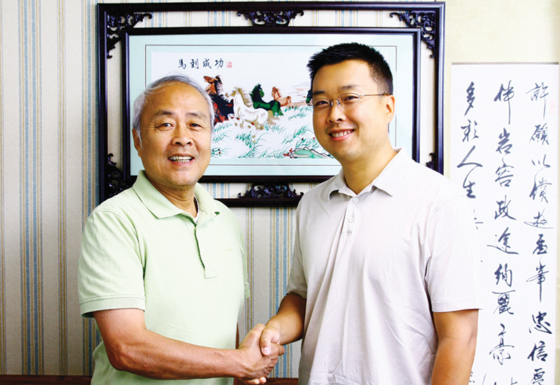 Hsu (R) shakes his father Paul Hsu’s hand upon his return to
the family business in 2011 after a successful career in the corporate sector.