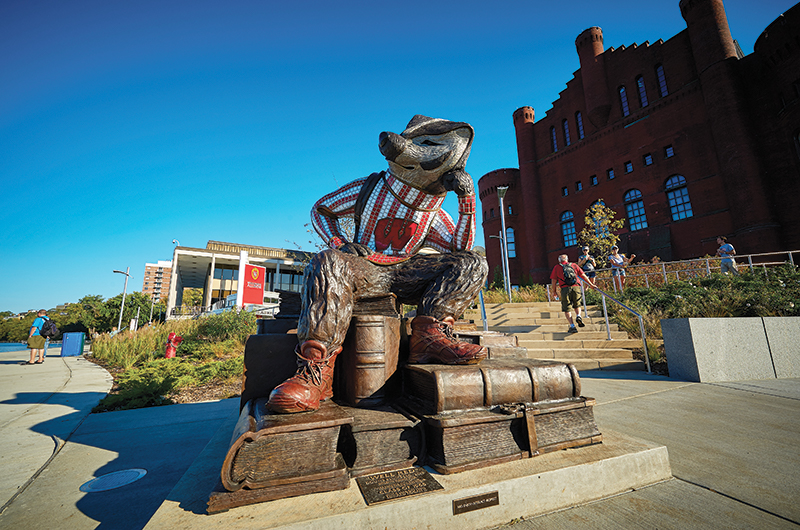 Alumni Park exhibit featuring Well Red, a sculpture of Bucky Badger wearing a backpack