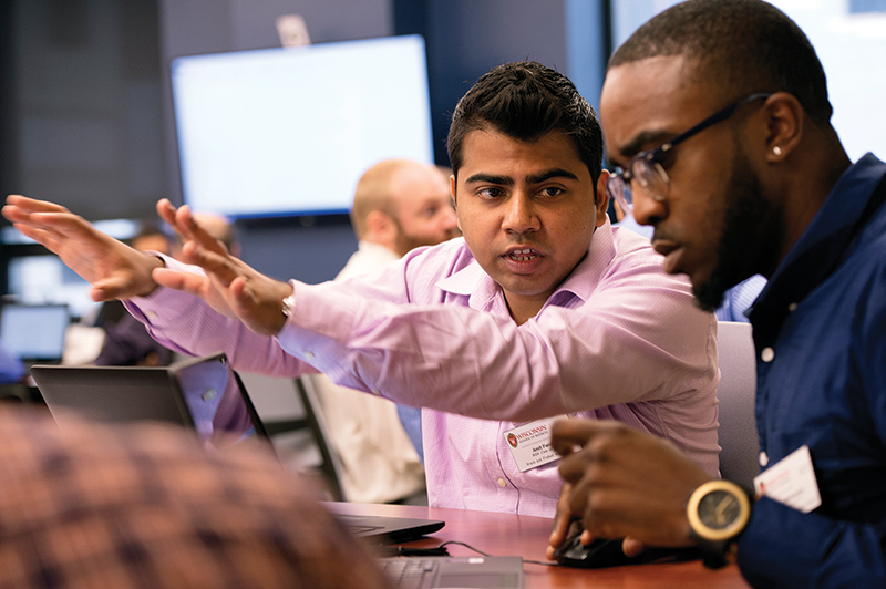 Two male WSB students working together