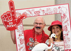 Wisconsin Homecoming. Man and woman framed by a large Badger-themed frame