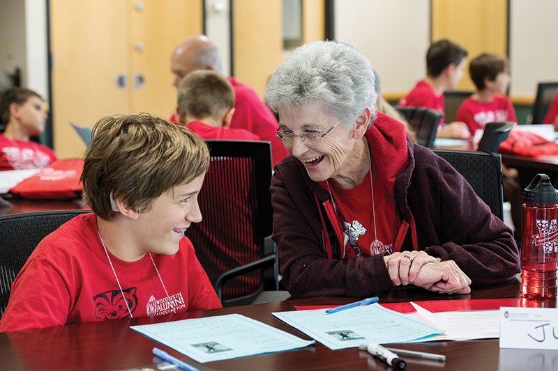 An elderly woman and young boy laugh together during UW–Madison’s
 Grandparents University (GPU), in which families take part in a two-day multigenerational learning experience on campus