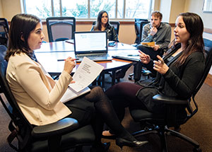 two women talking at a conference table; Making the Pitch