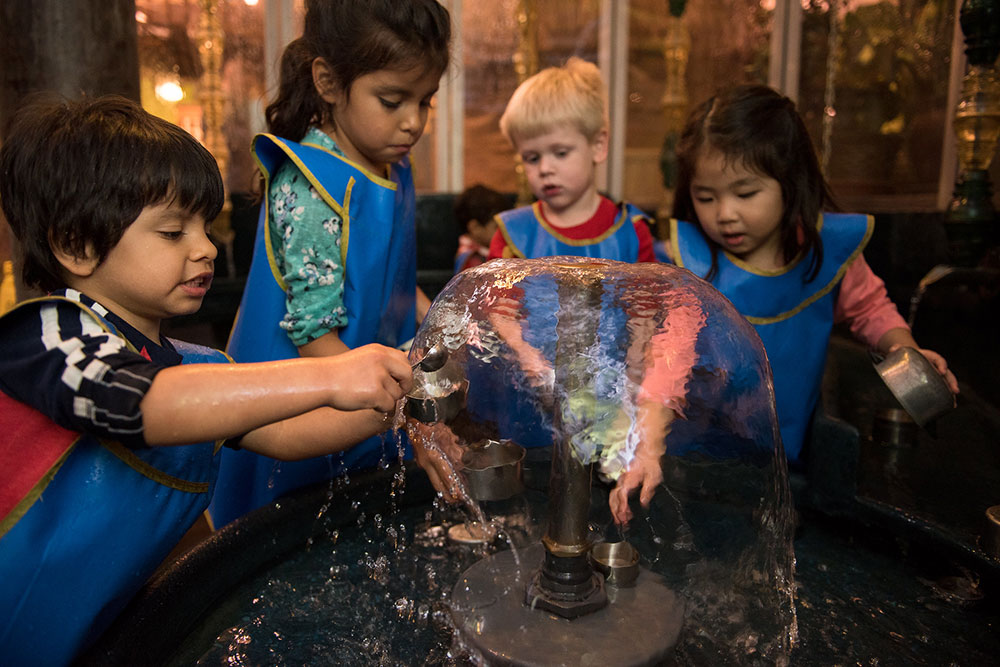 Four children explore a fountain exhibit at the Madison Children's Museum