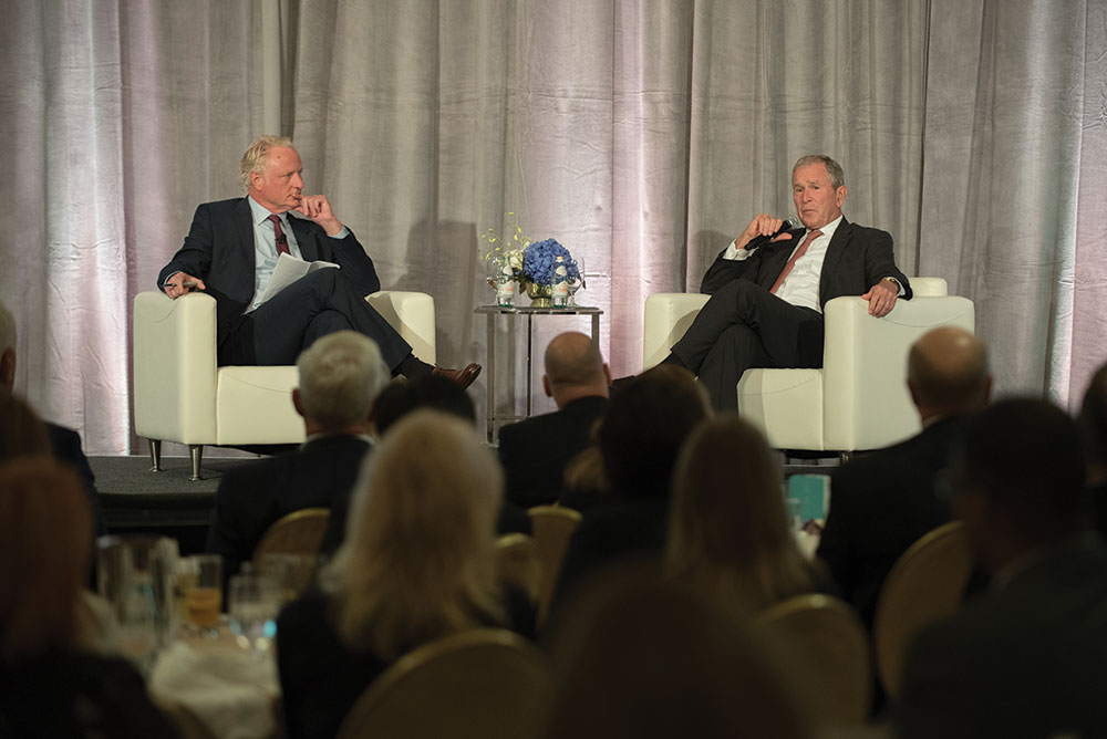 Mark Eppli, director of WSB’s James A. Graaskamp Center for Real Estate, looks on as former president George W. Bush speaks to an audience