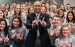 Wisconsin School of Business Dean Vallabh 'Samba' Sambamurthy in a lecture hall with a group of students