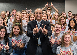 Wisconsin School of Business Dean Vallabh 'Samba' Sambamurthy in a lecture hall with a group of students