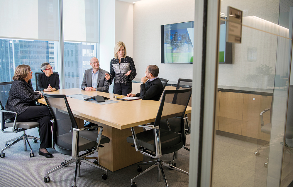 Julie Howard leads a meeting in a conference room of Navigant's downtown Chicago headquarters