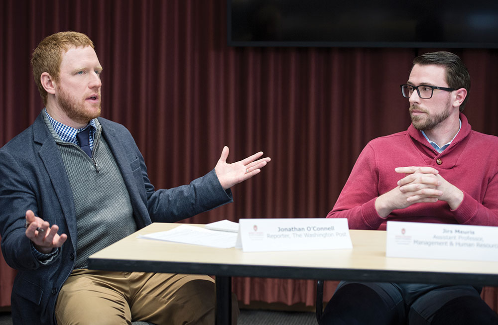 Washington Post reporter Jonathan O’Connell moderates a faculty panel discussion featuring Jirs Meuris, assistant professor of management and human resources at UW-Madison.